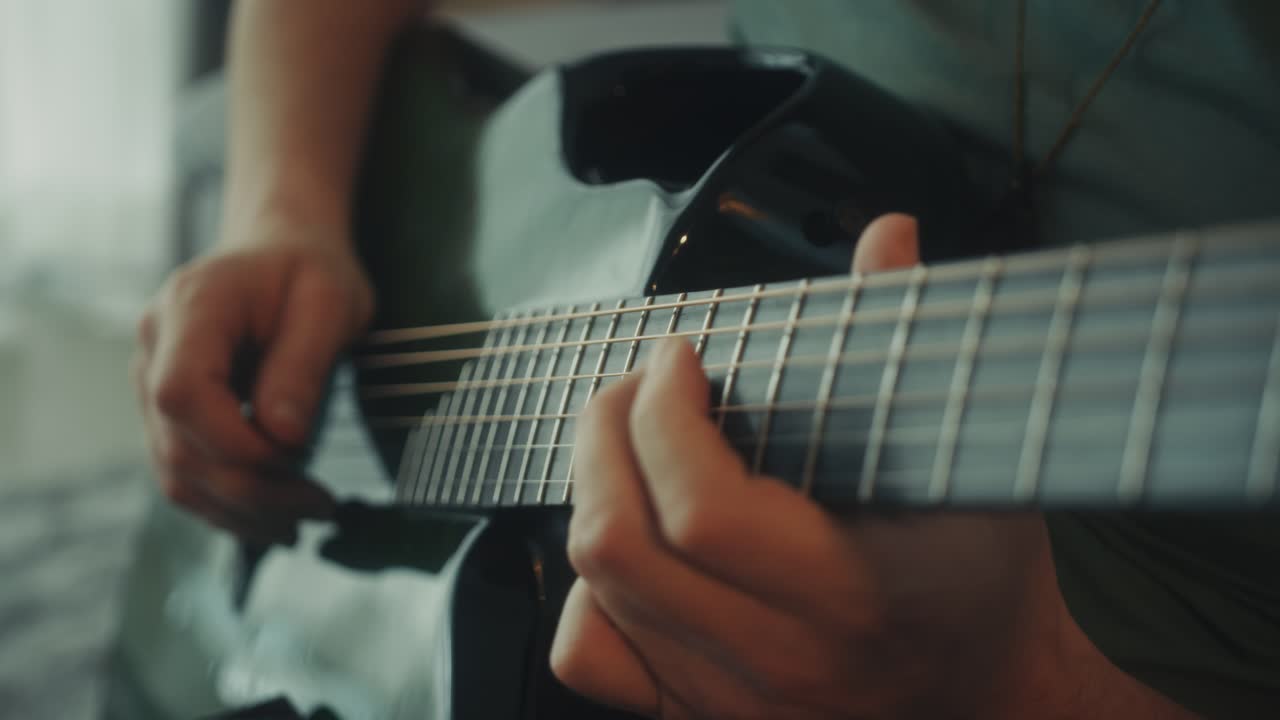 Primo piano di mani che suonano la chitarra acustica