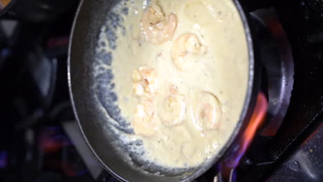 Cooking-ravioli-with-shrimp-in-sour-cream-in-cooking-pan