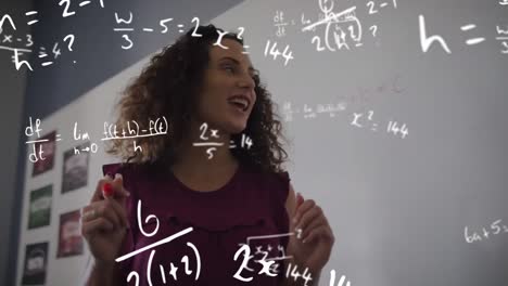 Animation-of-maths-calculations-over-smiling-biracial-female-teacher-teaching-in-classroom