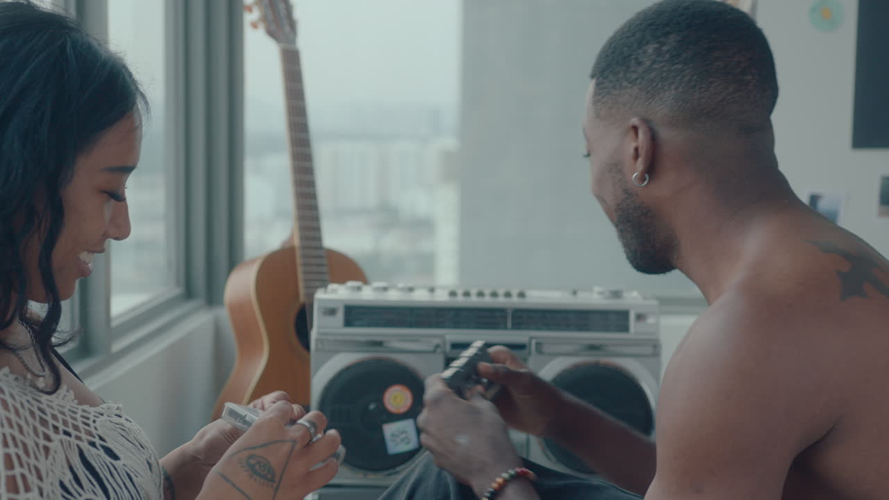Young Couple Listening to Cassette Tapes at Home