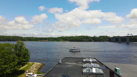 Drone-shot-descending,-showing-the-Kennebec-River,-lowing-down-to-show-food-stall-of-Dough-Boys,-fried-dough-food