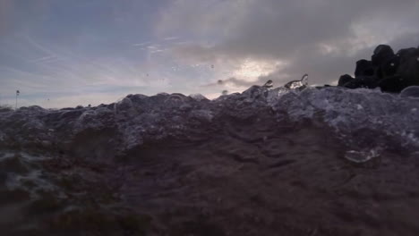 Water-level-view-of-waves-crashing-and-rolling-into-shore-in-slow-motion-5