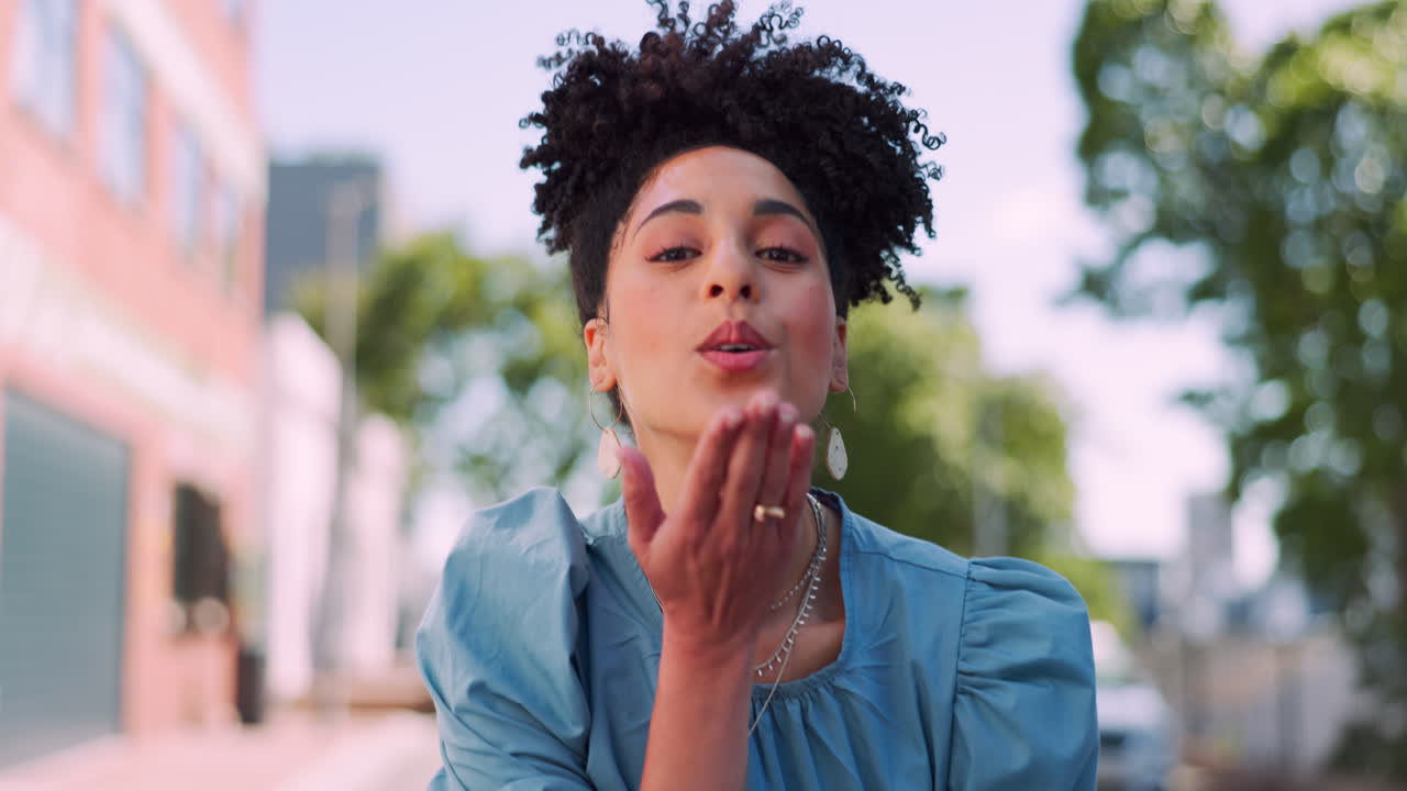 Black woman, face and smile with kiss in city