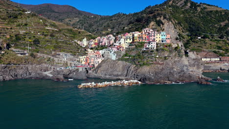 colorful houses on a cliffside along the coast of manarola, cinque terre, italy
