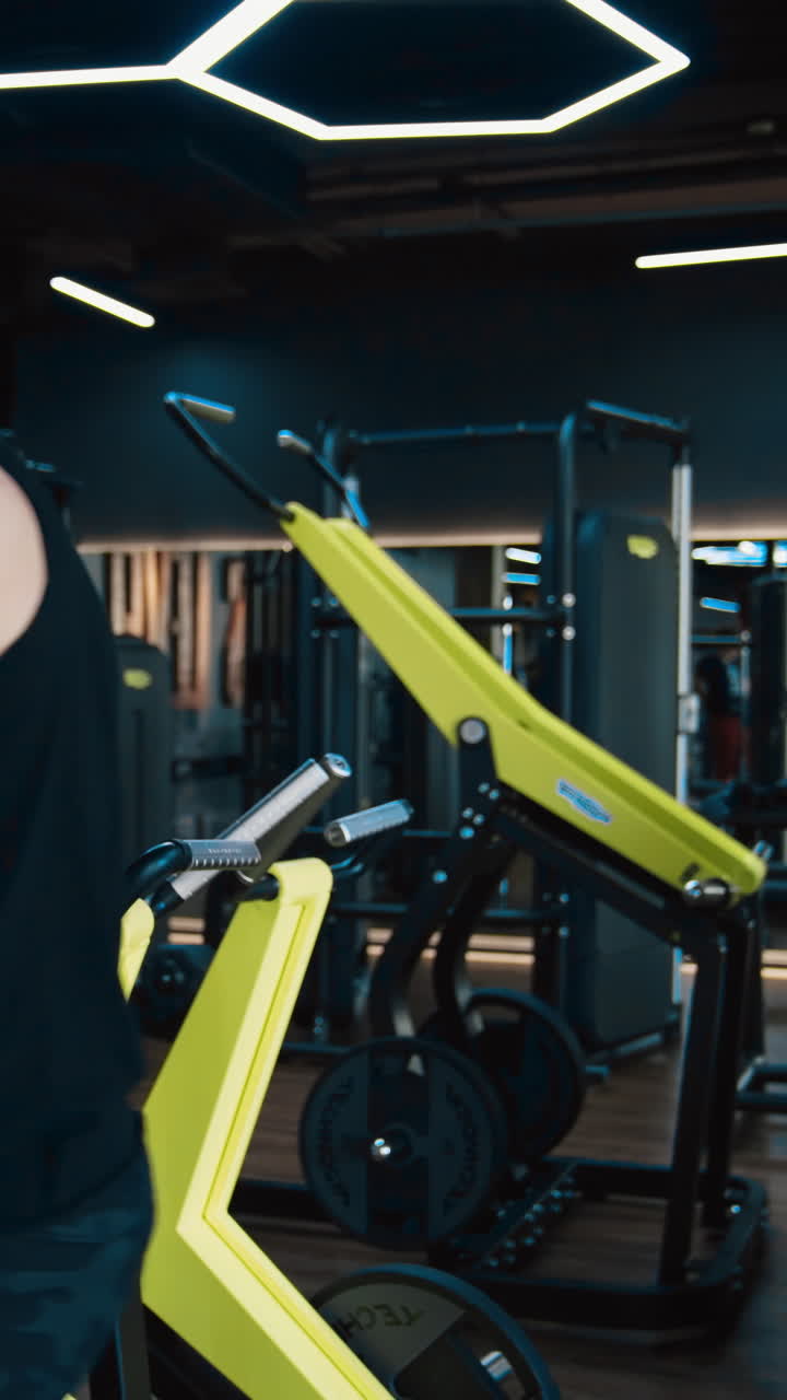 Muscular man exercising in the gym. Workout of people for athlete muscles inside fitness hall