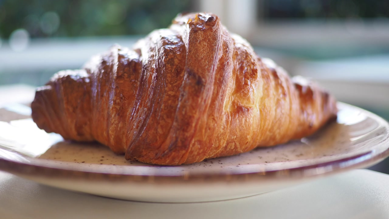 Delicious Golden Croissant on a Plate in Natural Light