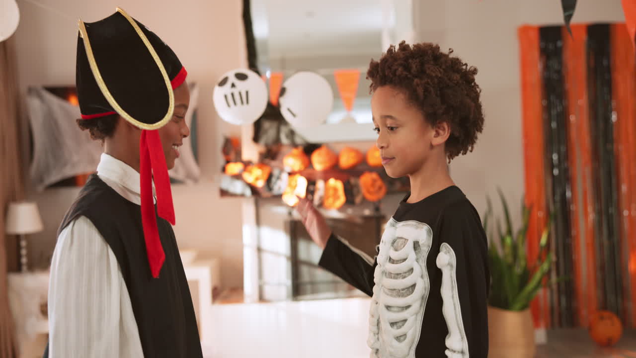 Kids in Halloween Costumes Celebrating at Home