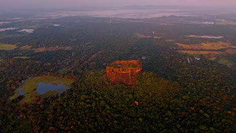 stunning aerial drone footage capturing the majestic sigiriya rock fortress at sunrise in sri lanka.