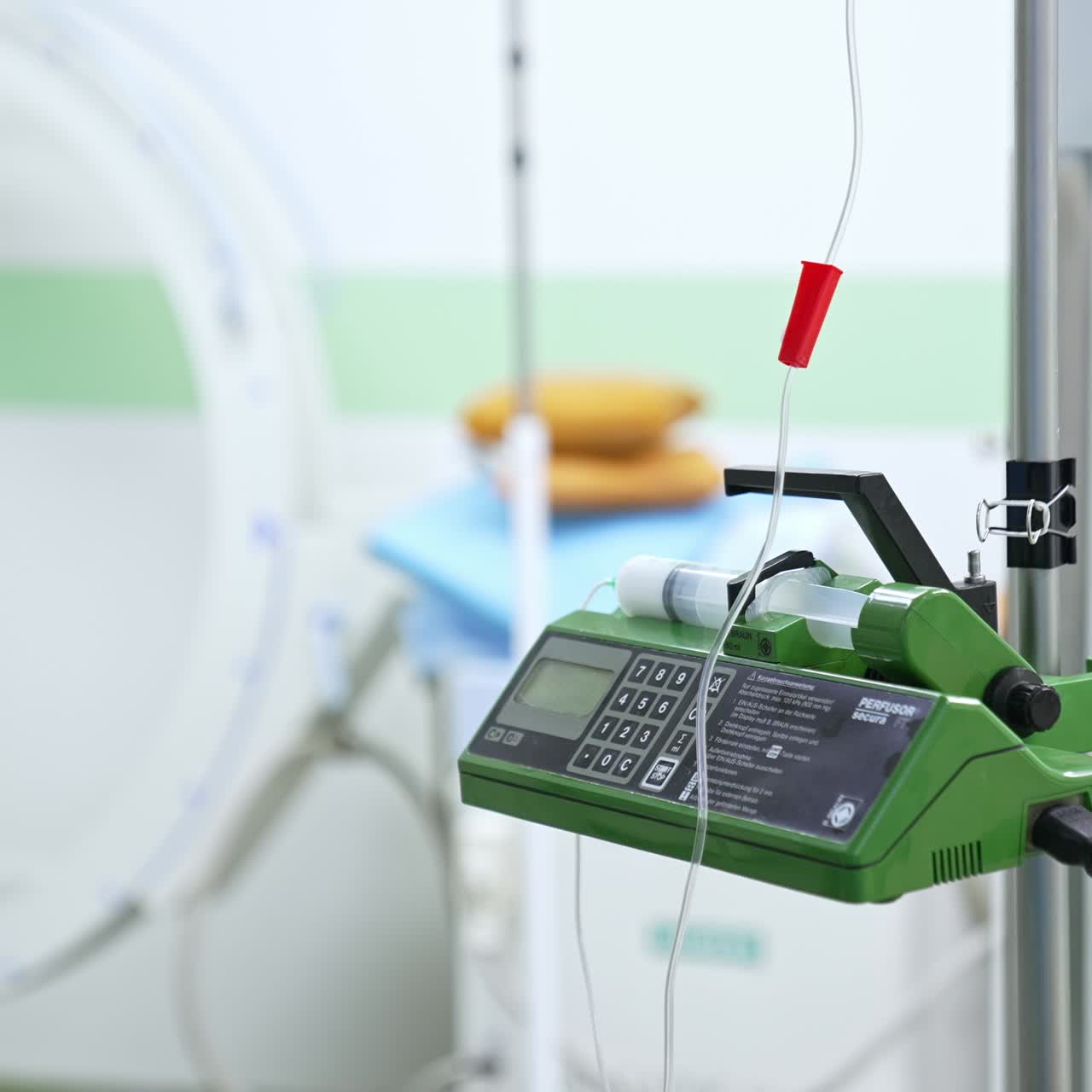 Modern advanced equipment in surgery room. Green device on a stand with tubes attached to it. Blurred background