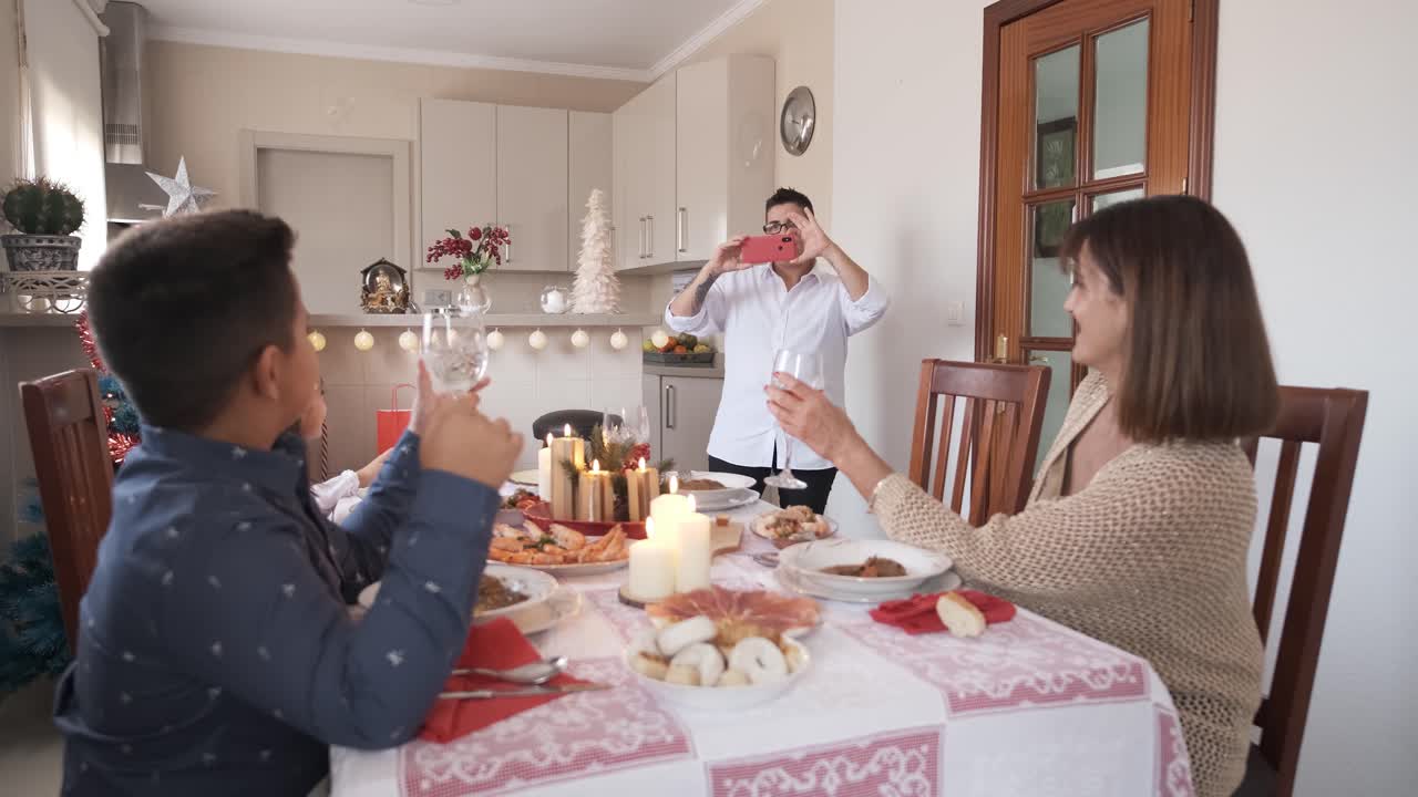 Happy family taking a photo during the Christmas lunch