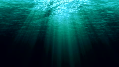 perfectly seamless loop of deep blue caribbean ocean waves from underwater background, light rays shining