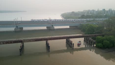 train going from bhayandar staton on vasai creek bridge wide bird eye view