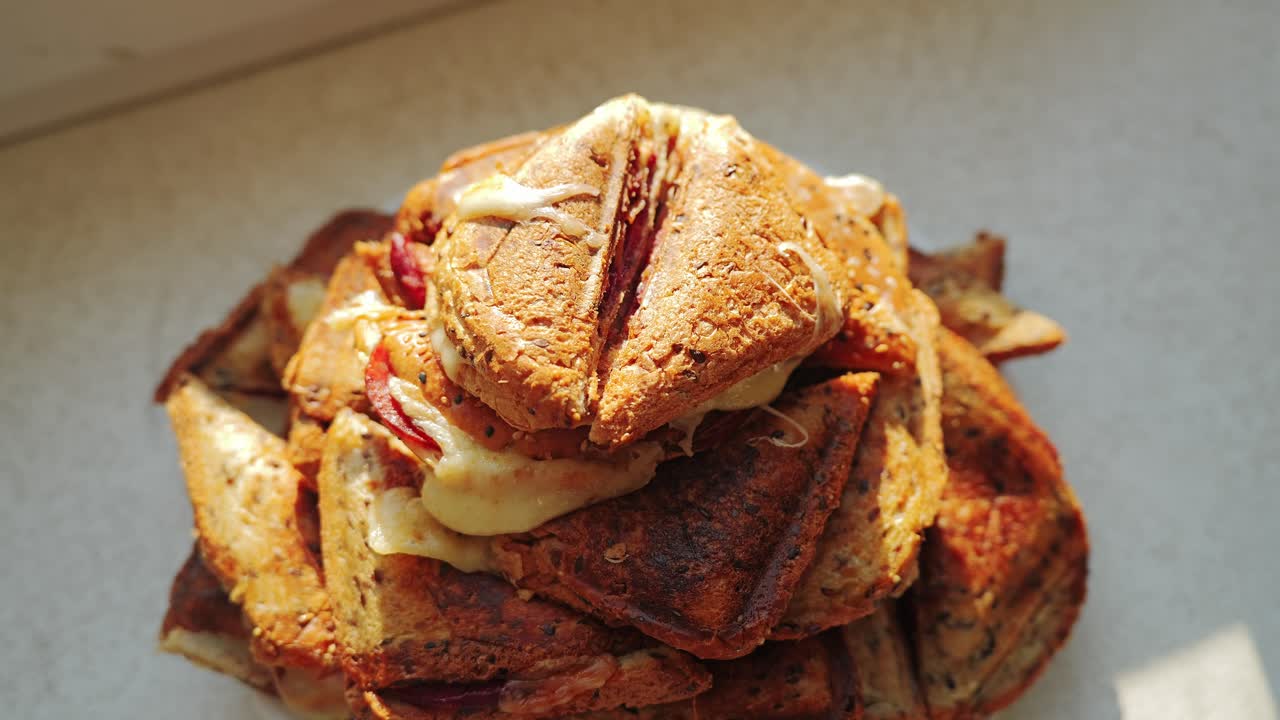 Top down camera slowly moves toward stacked toast glowing in cozy orange light