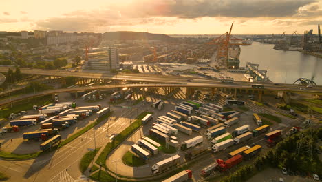 semi-trailer trucks parked on a parking lot near gdynia port at dusk in poland