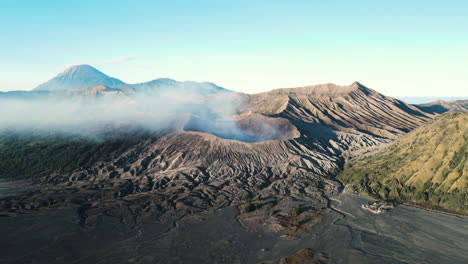 mount bromo actively puffing volcanic smoke early morning