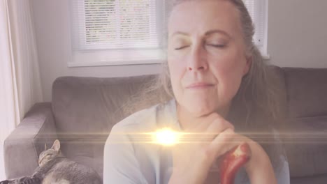 animation of glowing lights over a sad senior caucasian woman