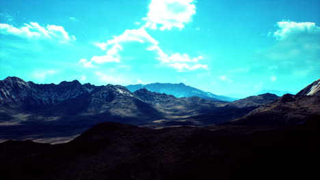 majestic mountain landscape with dramatic clouds in a clear blue sky