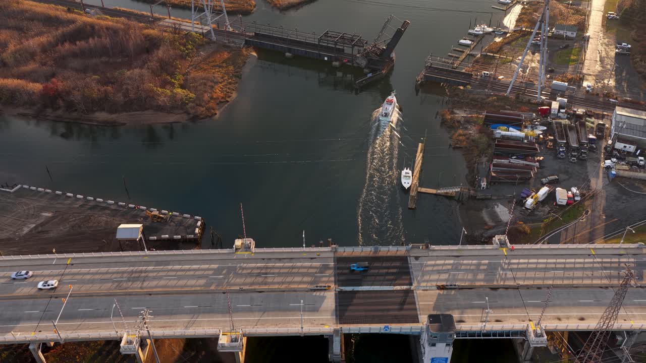 Aerial view of Cheesequake Bridge and a boat passing under a railroad bridge in Old Bridge, NJ