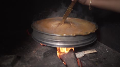 Indian-Traditional-Jackfruit-Dessert-Stirred-in-Firewood-Stove-|-Wide-Shot-|-Push-in-|-Slow-Motion