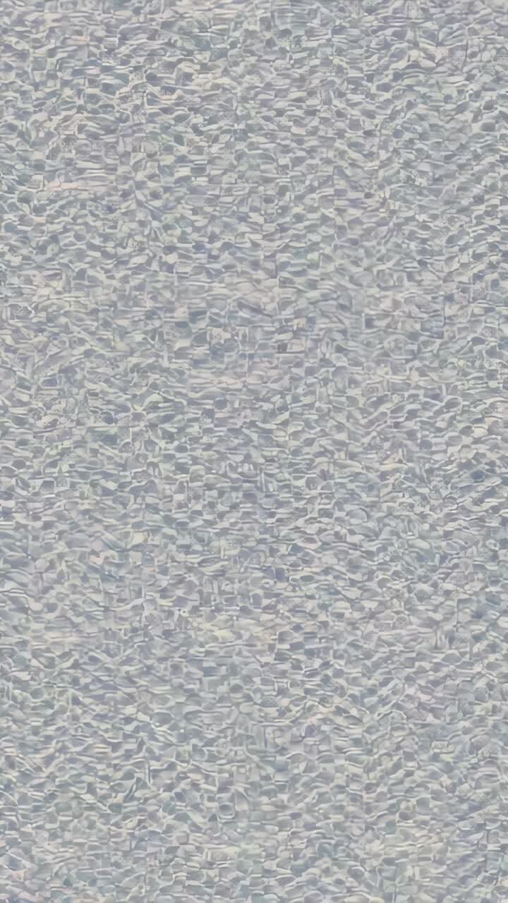 Vertical video: Zooming camera revealing crinkled surface in tight close-up, showing finer texture