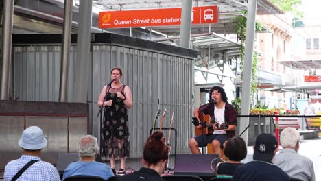 duo performing music for an audience outdoors