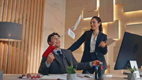 joyful businesspeople throwing money at office closeup. colleagues celebrating