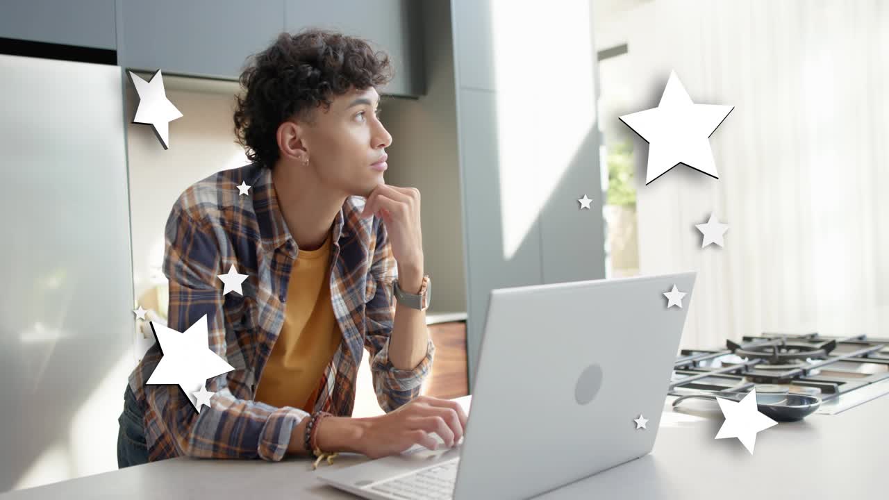 Adult male designer typing on laptop causing star overlays drifting around him for project