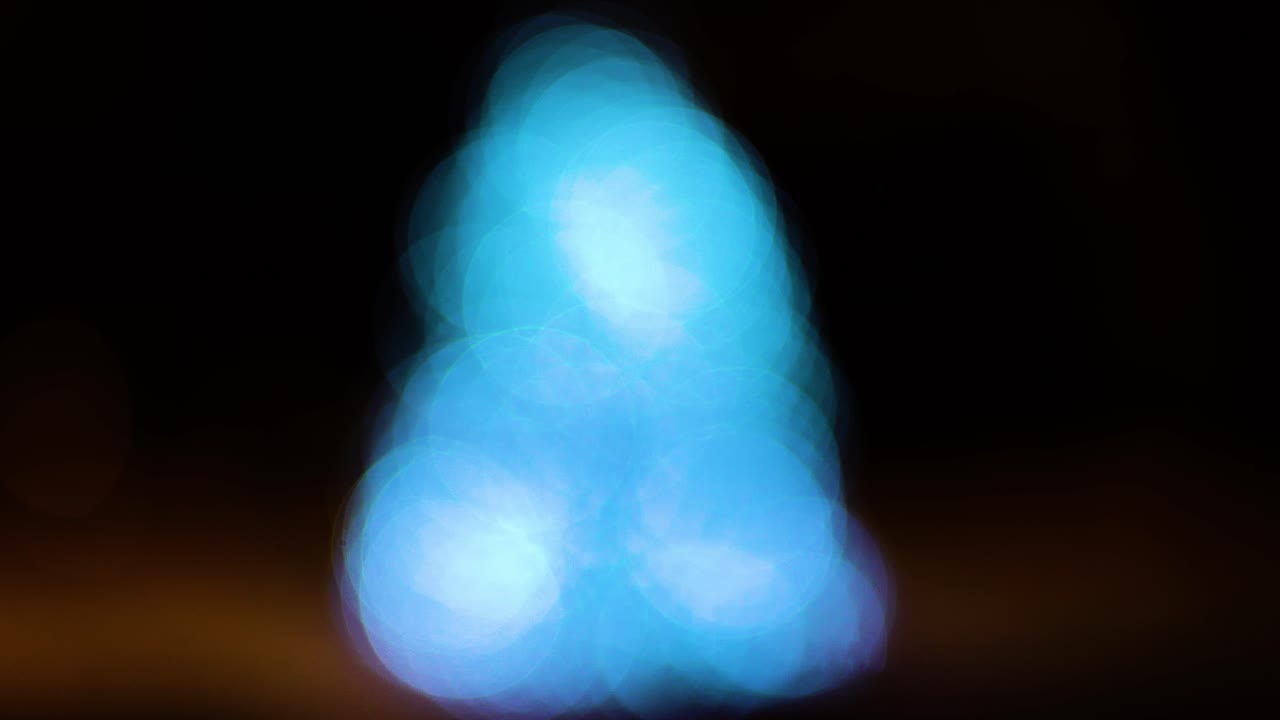 Blue light symbolizing flame, isolated on dark background