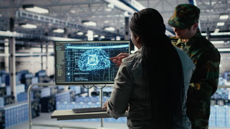 army experts in server room use artificial intelligence program