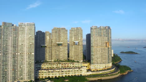 Aerial-lifting-shot-of-high-rise-residential-buildings-in-Hong-Kong-during-sunset