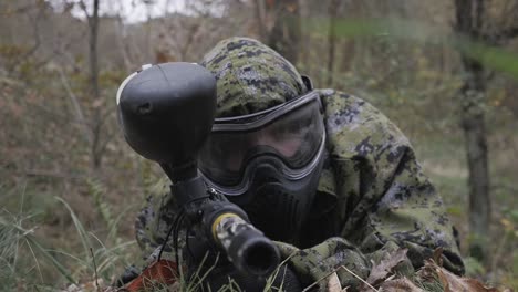 paintball player in camouflage gear