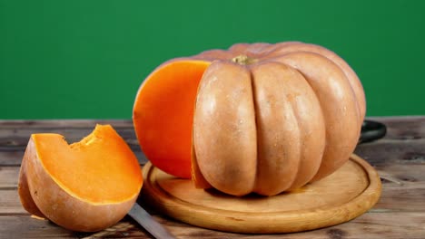 a piece of the big pumpkin falls on the table.