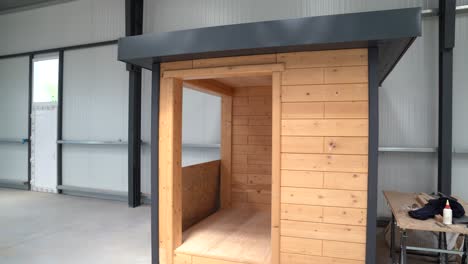 prefabricated wooden cabin structure under construction in industrial workshop