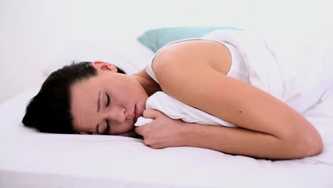 mujer pensativa acostada agotada en su cama