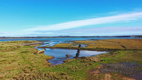 Aerial-flying-near-Tramore-Beach-in-Waterford,-Ireland-during-sunny-day