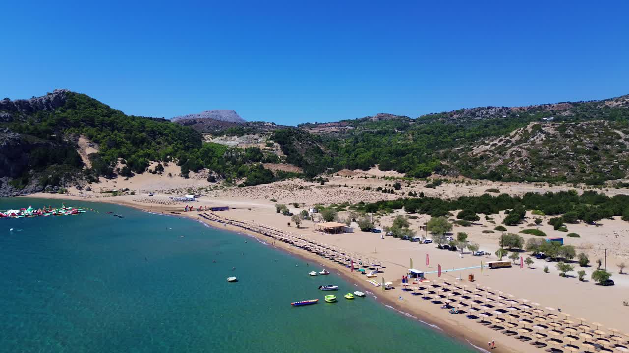Tsambika beach in Faliraki, Rhodes in Greece filmed with the drone from above with Mediterranean Sea in the summer holiday