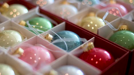 narrow focus on colorful christmas tree balls arranged in a box