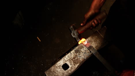 blacksmith working on a iron rod