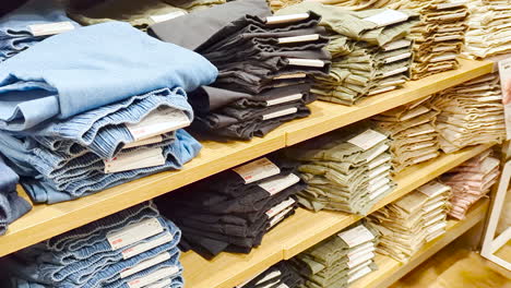 asian young woman shopping for pants in clothing store, concept of holiday end of week, lifestyle of asian woman.