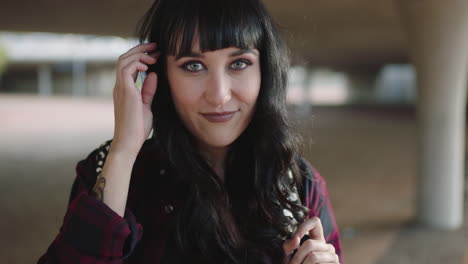 portrait of young stylish feminine woman smiling happy looking vulnerable