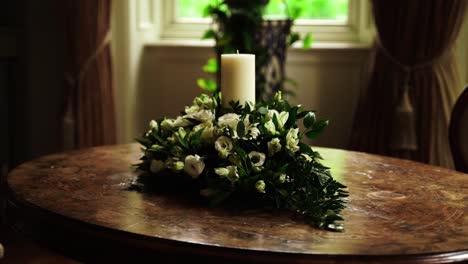 Wedding-Ceremony-Candle-on-a-Table-Surrounded-by-White-Roses