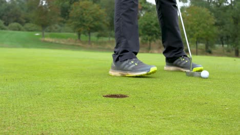 close up of a golfer preparing for a short putt