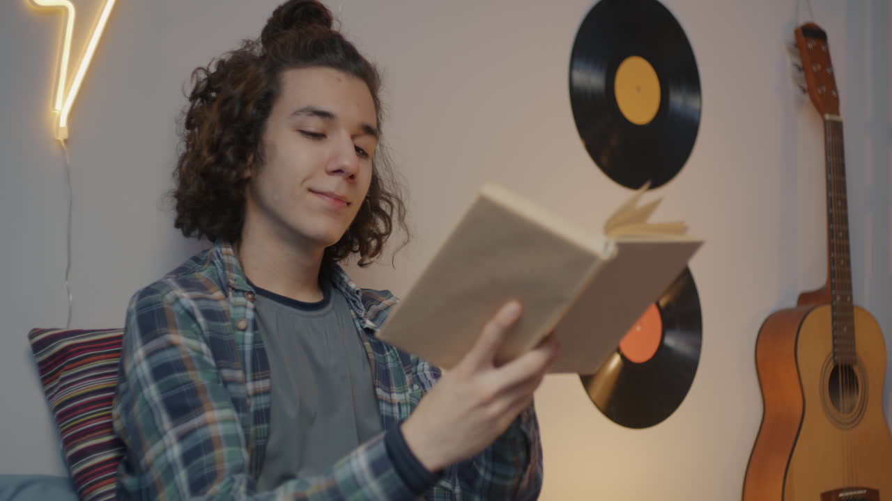 Teenage Boy Reading in His Room