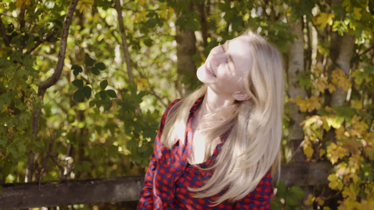 Woman in plaid shirt enjoying autumn nature