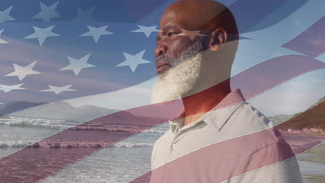 animación de la bandera de los estados unidos de américa sobre un hombre afroamericano en la playa
