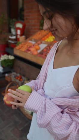 woman shopping for fruit at a market