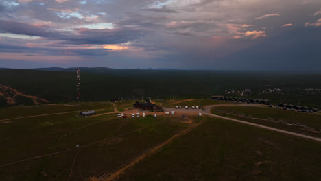 Drone-orbiting-the-summit-of-the-Kaunispaa-fell,-dramatic-evening-in-Lapland