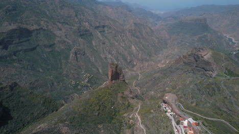 Fantastic-distant-aerial-shot-and-approaching-the-Roque-Palmes-that-is-located-on-the-island-of-Gran-Canaria-and-in-the-municipality-of-Tejeda