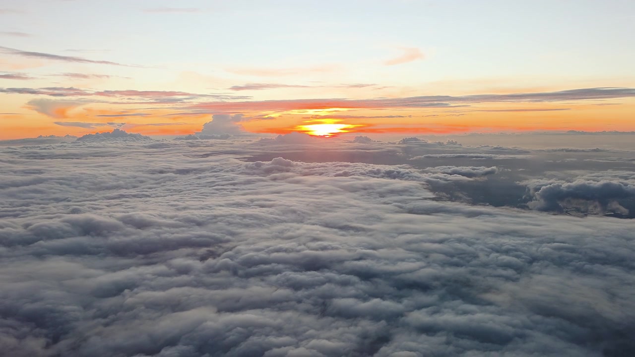 Luce del tramonto su uno strato di inversione nuvolosa sopra Taiwan, Asia orientale, mostra uno strato di nubi stratocumuli sotto e nubi cirri sopra durante la transizione atmosferica dell'ora d'oro serale, scattato da un aereo.