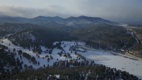 Ice-skating-skate-hockey-rink-lake-pond-hockey-winter-Etown-Evergreen-Lake-house-fishing-tents-Denver-golf-course-Colorado-aerial-cinematic-drone-sunset-golden-hour-winter-fresh-snow-slow-circle-right